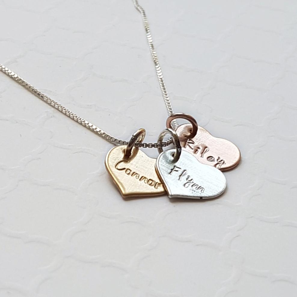 custom necklace with tiny hearts with stamped names in sterling silver, rose and yellow gold