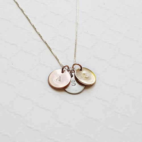custom necklace with tiny stamped initial discs in sterling silver, rose and yellow gold