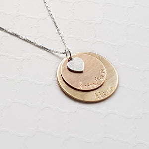yellow and rose gold mixed metal mom necklace with kids' names and heart charm