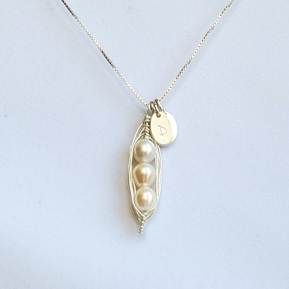 Wire-wrapped sterling silver pea pod necklace with freshwater pearls and initial charms