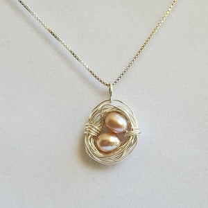 Wire-wrapped sterling silver bird's nest necklace with freshwater pearl eggs