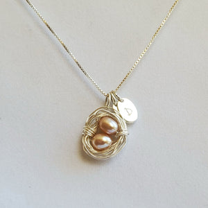 Wire-wrapped sterling silver bird's nest necklace with freshwater pearl eggs and initial charms