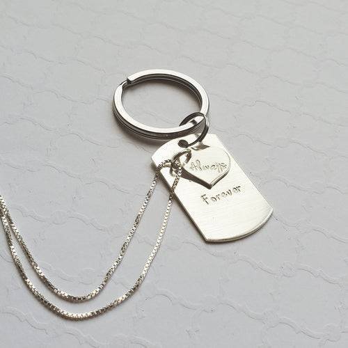 sterling dog tag keychain with heart cut-out on a sterling necklace reading 