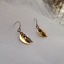 Load image into Gallery viewer, sterling silver hook earrings with hammered yellow gold disc and silver leaf charm