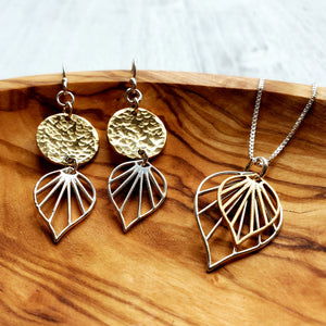 necklace with silver and gold palm leaf pendants, and earrings with yellow gold discs and silver palm leaves