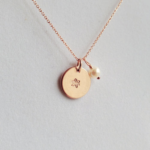 rose gold disc necklace stamped with birth flower, with freshwater pearl dangle charm