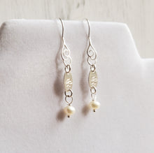 Load image into Gallery viewer, sterling silver hook earrings with swirl pattern, freshwater pearls, and disc stamped with birth flower