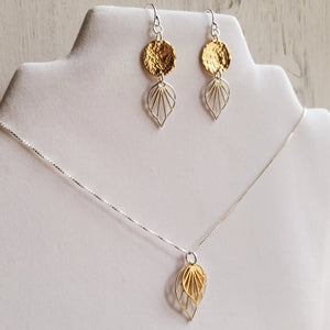 necklace with silver and gold palm leaf pendants, and earrings with yellow gold discs and silver palm leaves