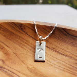 tiny sterling silver tag necklace stamped with birth flower and initial